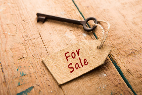 real estate sale concept - old key with tag - Fotó, kép