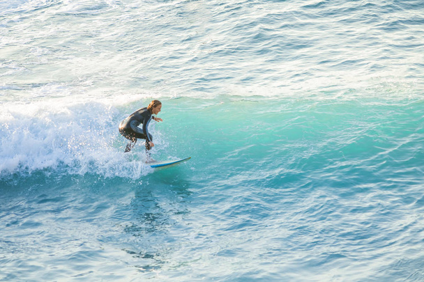Bogliasco, Italy, October 6, 2017:  Woman surfer riding a wave - Foto, imagen