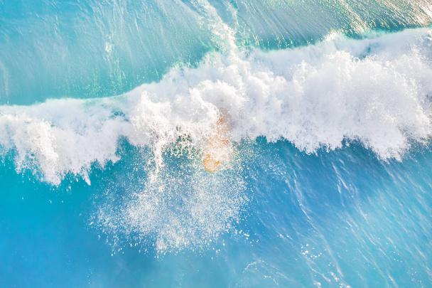 Yellow surfboard covered with wave, top view - Foto, Imagem