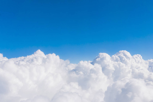 White fluffy clouds against a blue sky, background - Fotó, kép
