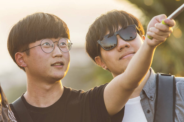 Firenze, Italy, October 12, 2017:  Two Asian guy in glasses make selfies - Fotoğraf, Görsel