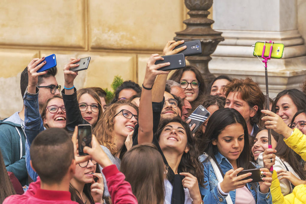 Palermo, Italy, October 31, 2017: A crowd of youn people do selfie on their phones - Fotografie, Obrázek