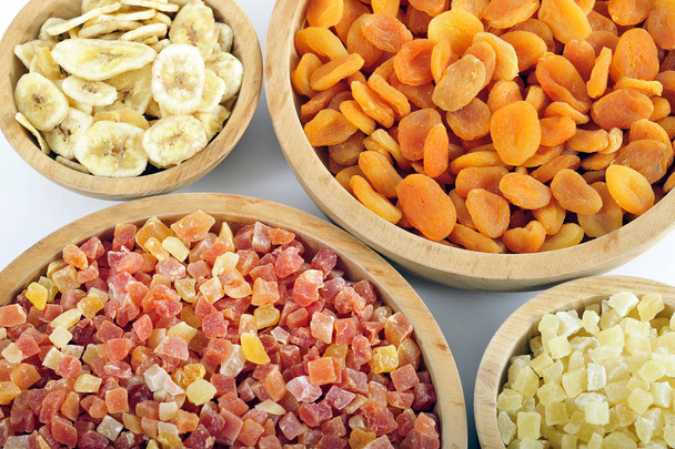 Dried and candied fruits in wooden bowls - Foto, imagen