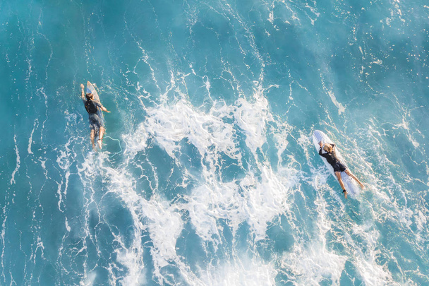 Dos surfistas en el océano, vista superior
 - Foto, Imagen