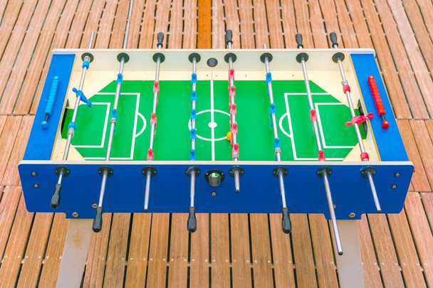 Football table on a wooden plank floor - Photo, image