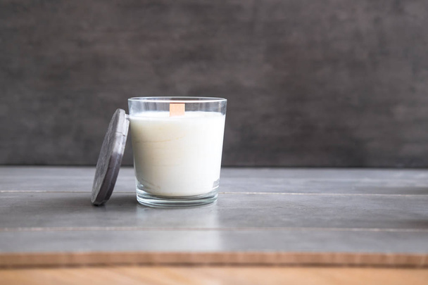 Organic scented soy candle on grey concrete cement table. Loft interior decor, minimalism concept.  Closeup, copy space for text - Foto, Imagem