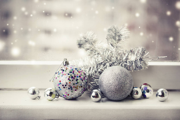 closeup view of colorful christmas decorations in vintage style at window sill - Photo, Image