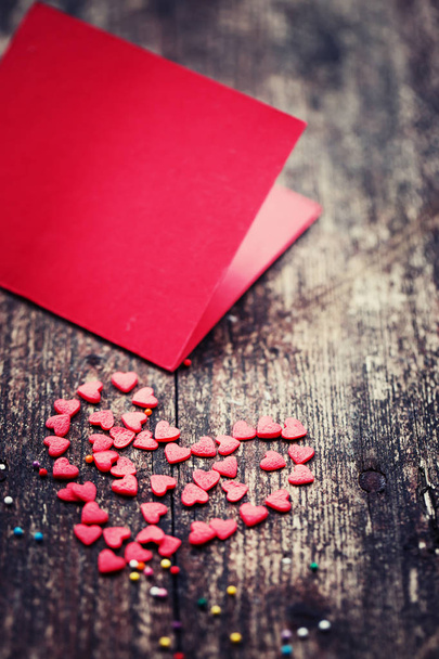 Colorful romantic hearts with red template on wooden background - Photo, image