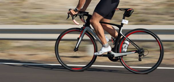 Motion blur of a bike race with the bicycle and rider at high speed - Photo, Image