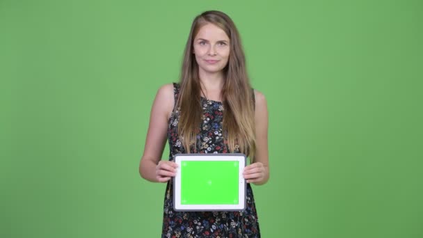 Young happy pregnant woman showing digital tablet - Metraje, vídeo