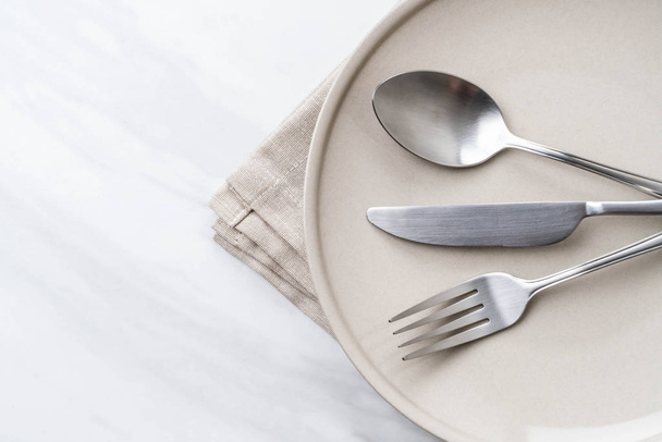 empty plate spoon fork and knife on table - Valokuva, kuva