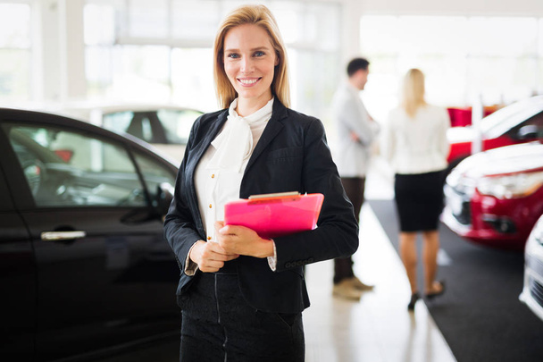 Professional gorgeous saleswoman at car dealership in formal wear. Super consultant or manager - Φωτογραφία, εικόνα