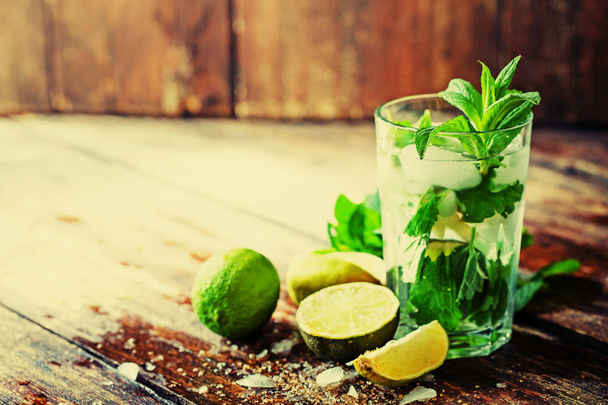 closeup view of fresh homemade mojito in glass on wooden table  - Фото, изображение