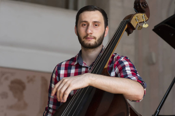 Double bass player playing contrabass Portrait - 写真・画像