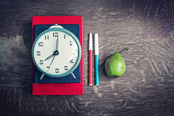 closeup view of clocks, books and different school supplies on wooden table - Foto, immagini