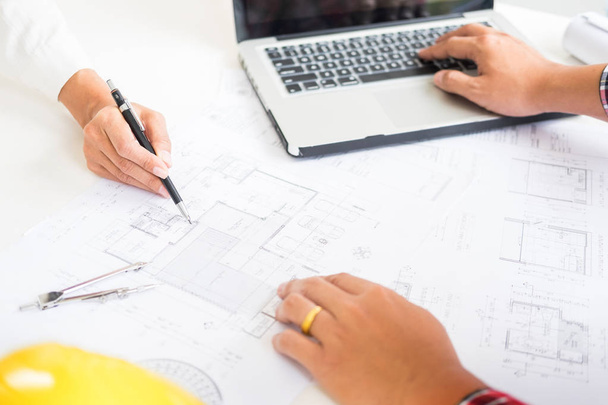 Close-up Of Person's engineer Hand Drawing Plan On Blue Print with architect equipment, Architects discussing at the table, team work and work flow construction concept. - 写真・画像