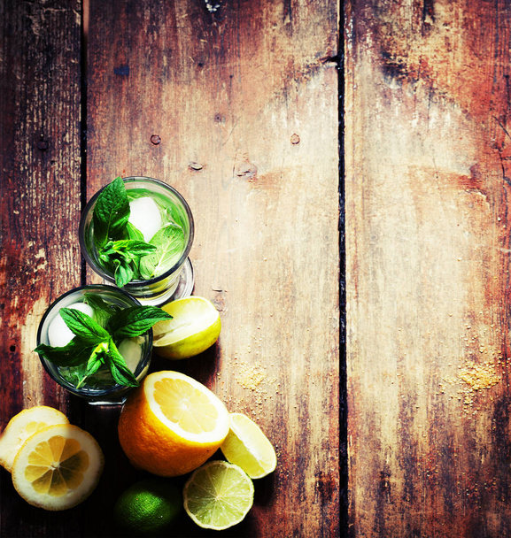 closeup view of fresh homemade mojito in glass on wooden table  - Фото, зображення