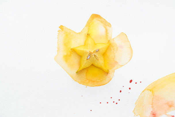 top view of yummy yellow star fruit on white surface with yellow watercolor - Photo, Image