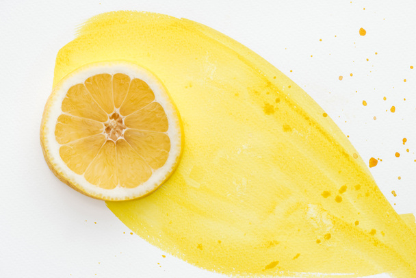 top view of yummy lemon piece on white surface with yellow watercolor - Фото, зображення