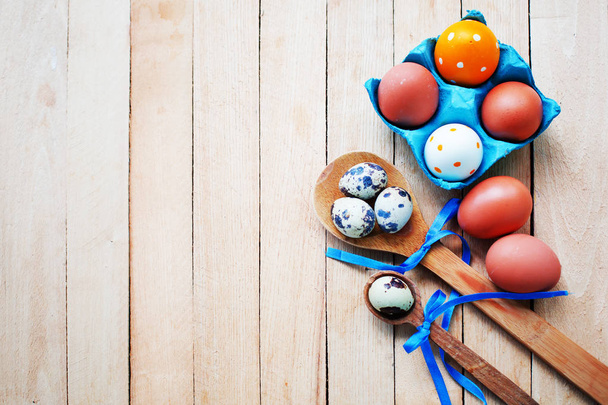 elevated view of easter eggs in spoons on wooden background - Fotografie, Obrázek