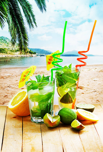 closeup view of fresh homemade mojito in glass on wooden table  - Foto, Imagen