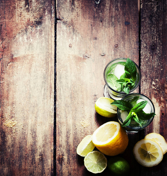 closeup view of fresh homemade mojito in glass on wooden table  - Foto, imagen