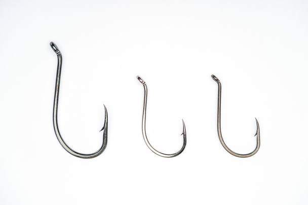 elevated view of three fishing hooks placed in row isolated on white  - Photo, Image
