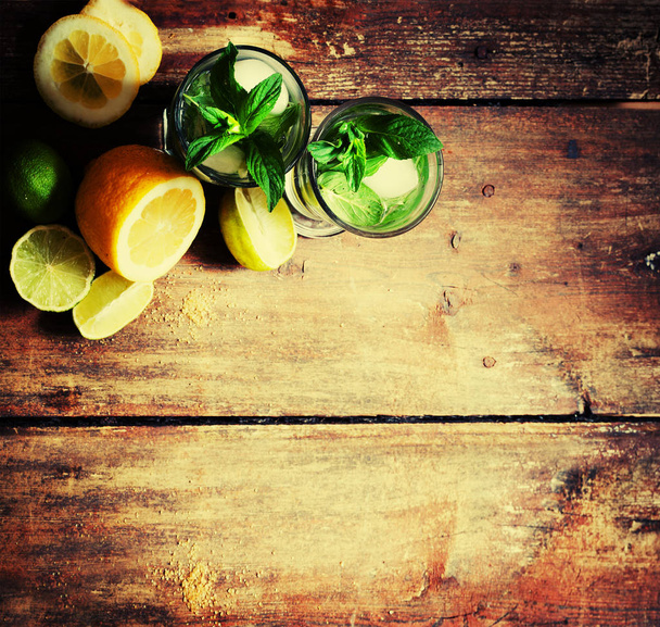 closeup view of fresh homemade mojito in glass on wooden table  - Фото, зображення