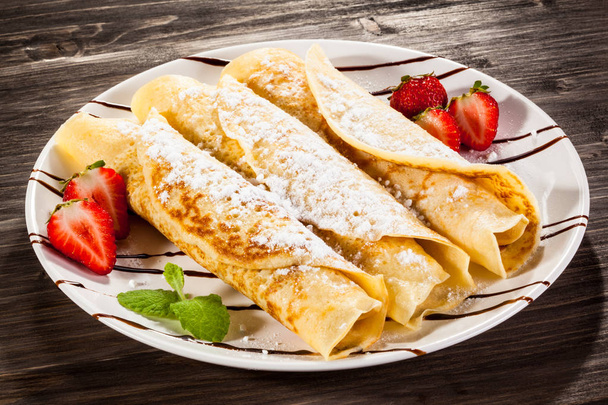 Sweet crepes stuffed with banana and strawberries - Fotoğraf, Görsel