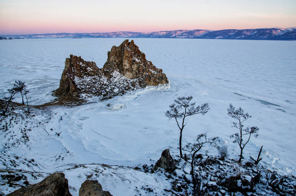 Shamanka rock in winter at sunrise. Olkhon island, Baikal lake, Siberia, Russia. - Photo, Image
