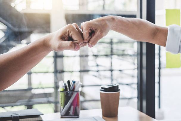 Teamwork of businessman partnership giving fist bump to greeting start up contract for both companies business strategy project. - Φωτογραφία, εικόνα