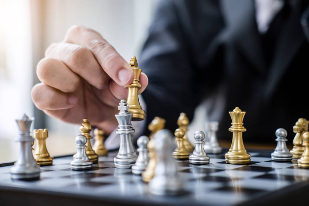 Hands of confident businessman playing chess game to development analysis new strategy plan, leader and teamwork concept for win and success. - Fotó, kép