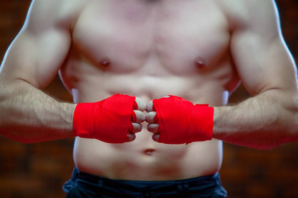 Christmas. Muscular Fighter kickbox boxing Santa Claus With Red Bandages the background of a brick wall. - 写真・画像