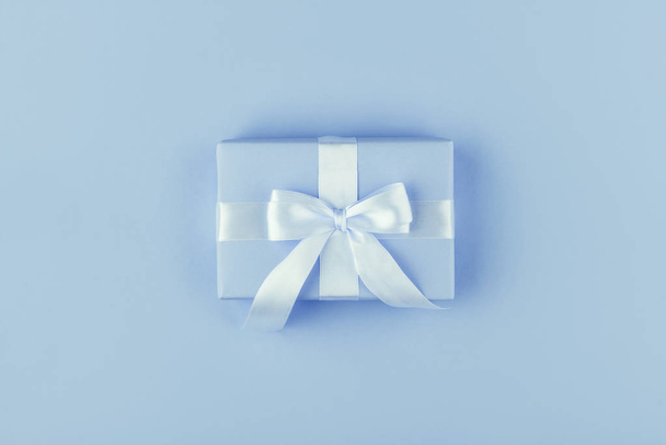Gift or present box on blue table top view. Flat lay. Birthday, wedding or christmas concept. - Foto, immagini