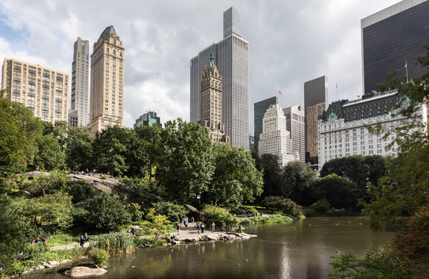New York, USA - Sep 24, 2018: Pond in the central park in NYC. Central Park and Manhattan Skyline. Midtown Manhattan skyline view from Central Park - Photo, Image