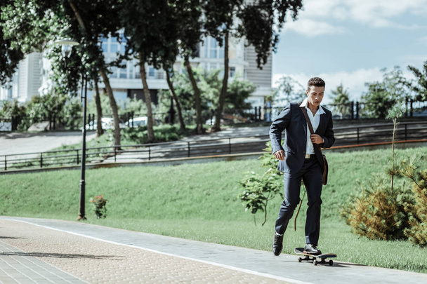 Young male student practicing riding on skateboard - Fotografie, Obrázek
