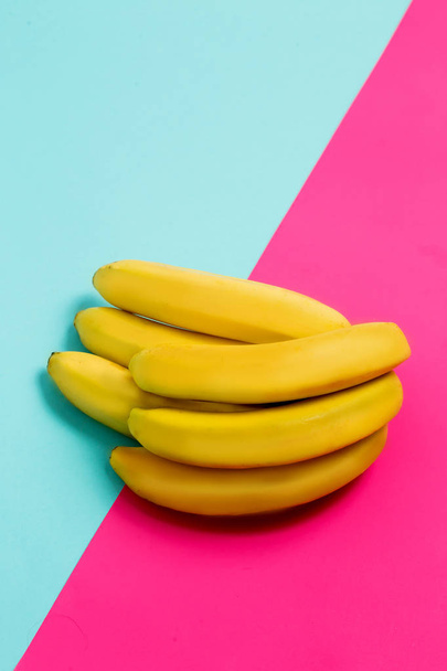Close up of a bunch of bananas on a colored background. - Φωτογραφία, εικόνα