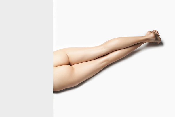 Moda foto de arte de Sexy Naked Girls Booty. Corpo de mulher nua no chão. seu texto aqui
 - Foto, Imagem