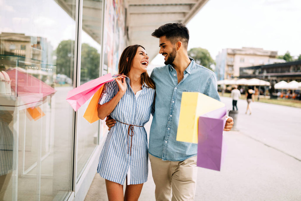 Happy attractive loving couple enjoy spending time in shopping together - Fotoğraf, Görsel