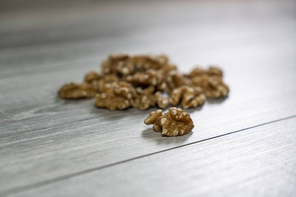 some shelled walnuts on the wooden table - 写真・画像