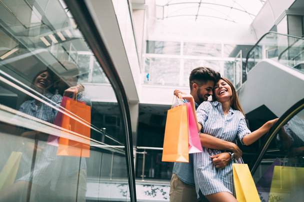 Happy attractive loving couple enjoy spending time in shopping together - Photo, Image