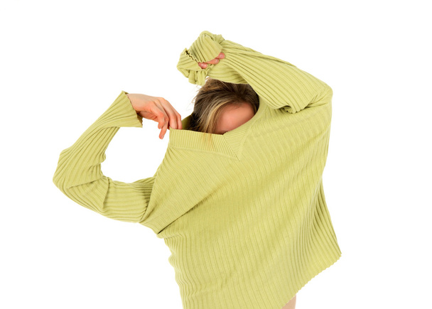 Funny girl takes off a green sweater - Foto, immagini