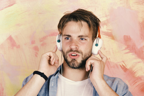 Musical lifestyle. Cheerful teenage dj listening songs via earphones. - Photo, Image