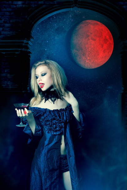 Aggressive vampire woman with glass of wine - Fotografie, Obrázek