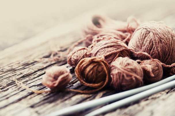 Colorful threads and knitting needles on wooden background - Valokuva, kuva