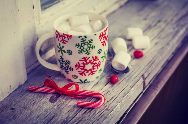 closeup view of coffee cup with marshmallows and christmas decorations over wooden table - Фото, зображення