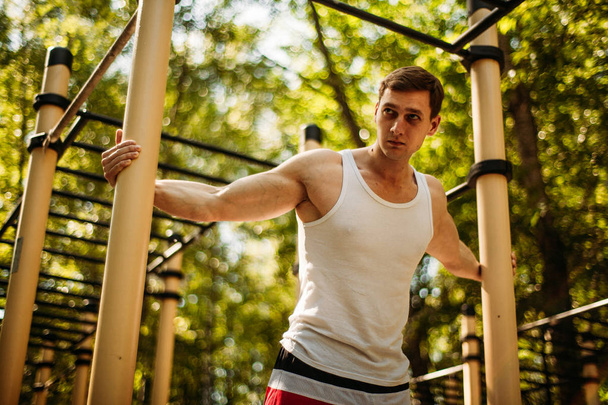 Handsome young man training in the park. - Fotografie, Obrázek