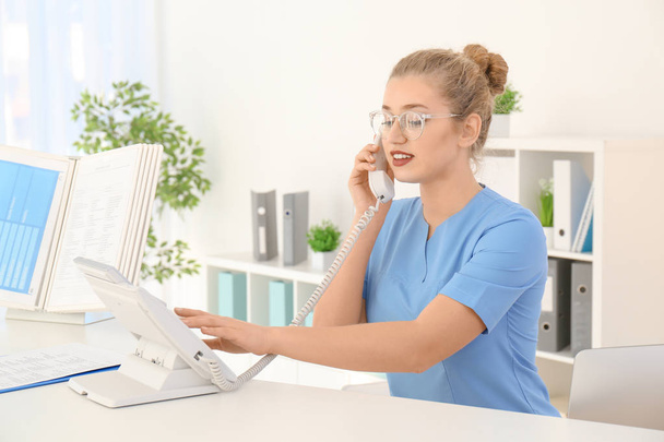 Telephone and receptionist with trainee in hospital - Fotografie, Obrázek