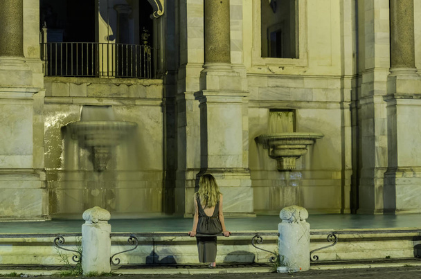 Young charming girl near the Aqua Paola fountain in Rome at night - Zdjęcie, obraz