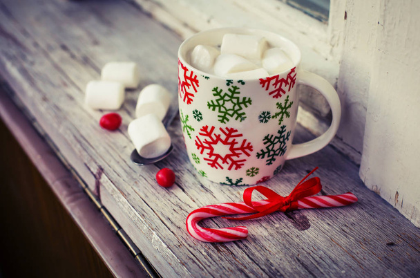 closeup view of coffee cup with marshmallows and christmas decorations over wooden table - Foto, Imagem